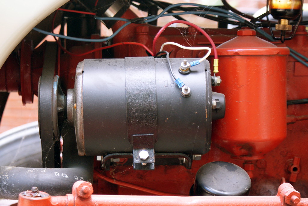 A gray generator motor stands out next to red components.