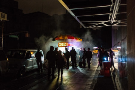 A single illuminated food stand near Union Square during the New York City blackout following Superstorm Sandy.