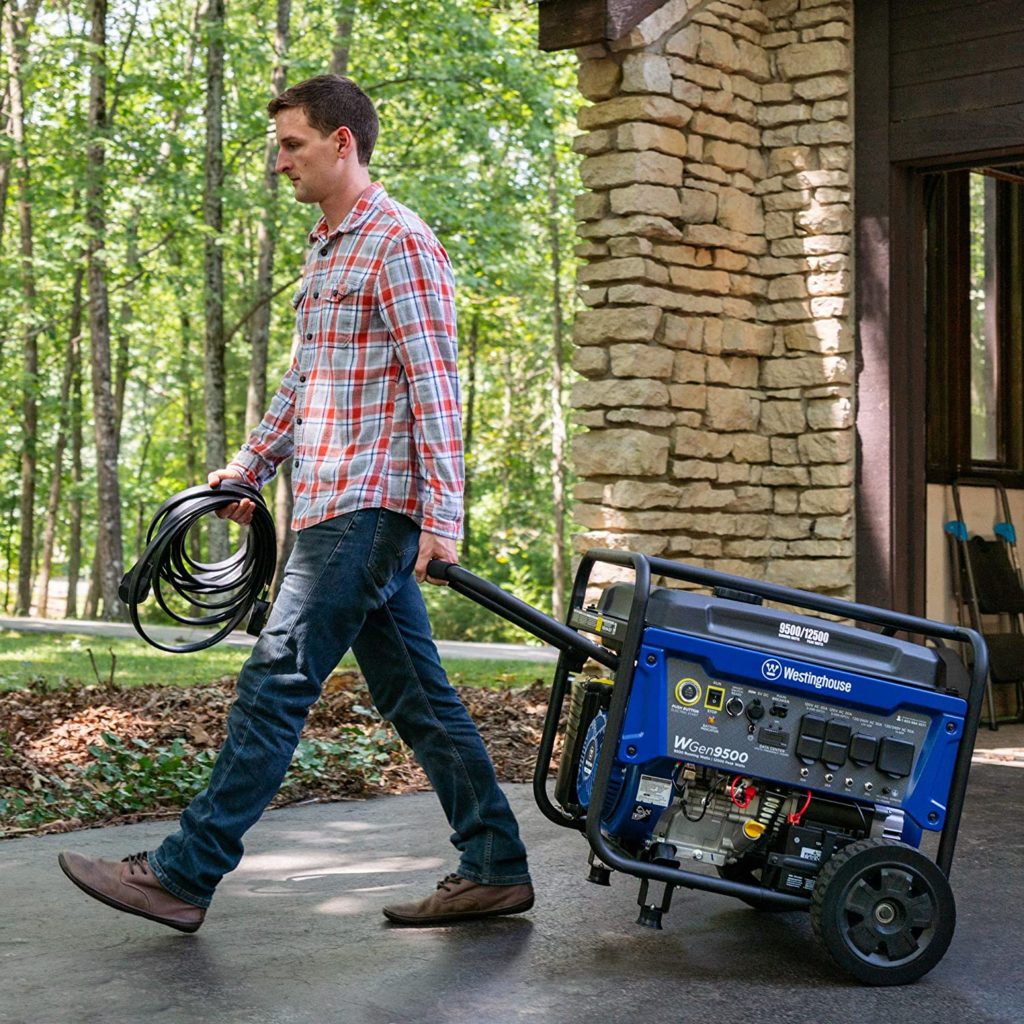 Man pulling WGen9500 with one hand across driveway.