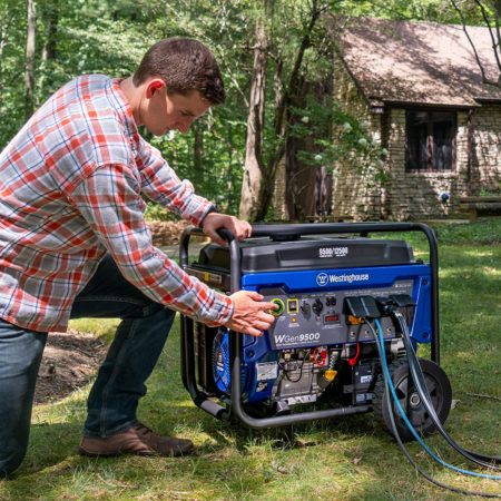 A man kneels next to a Westinghouse WGen9500 portable generator providing power in a backyard.