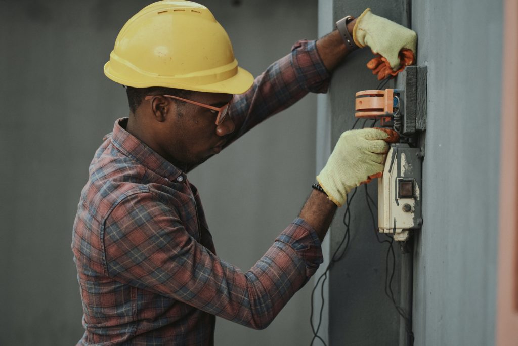 A civil engineer wearing a yellow hard hat measures load capacity.